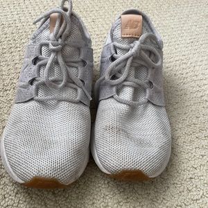 grey new balance shoes with brown tags